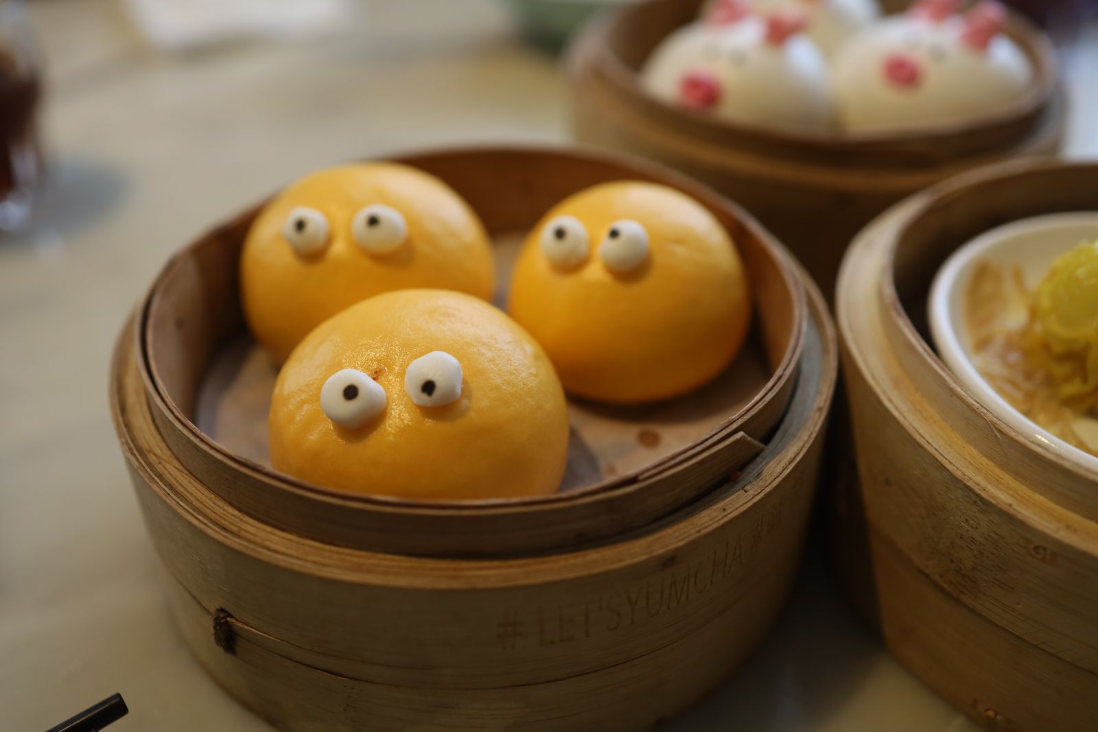 The cute appearance of Hot Custard Molten Bun (睇住流奶), with salted duck egg and custard inside.