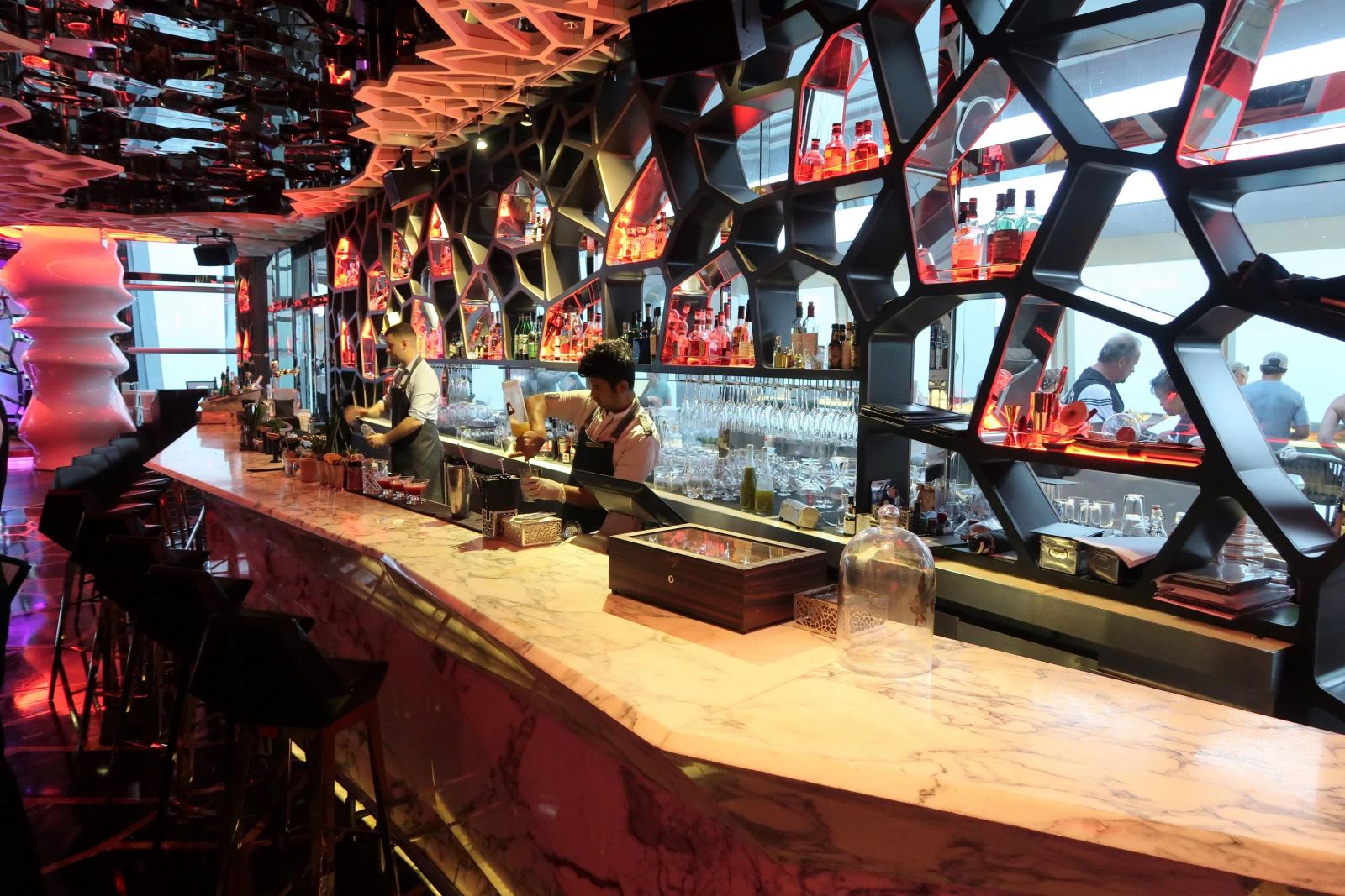 OZONE is split up into an open-air terrace, a long marble bar with stools, lounge areas, and a mini sushi restaurant